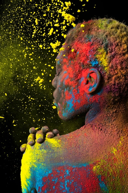 Beautiful woman with colorful powder close up