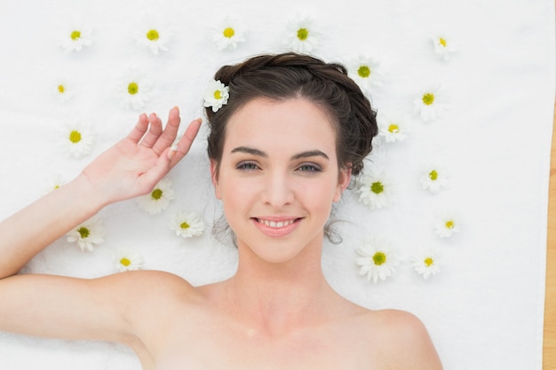 Beautiful woman with flowers in beauty salon