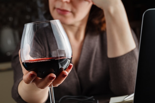 Beautiful woman with glass red wine