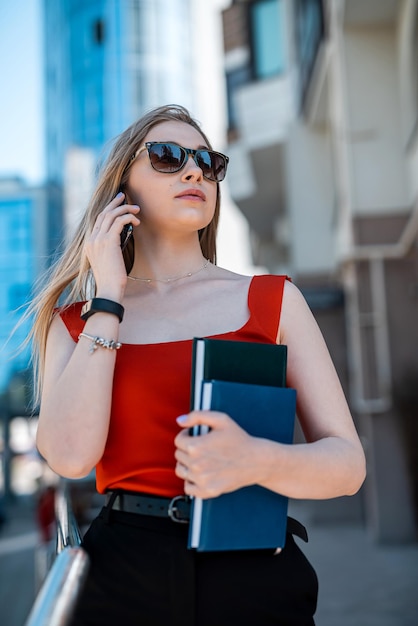 Beautiful woman with glasses and walking and talking on mobile phone Wireless communication