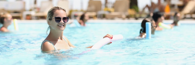 Beautiful woman with healthy body and vitality enjoys summer day in pool active and healthy