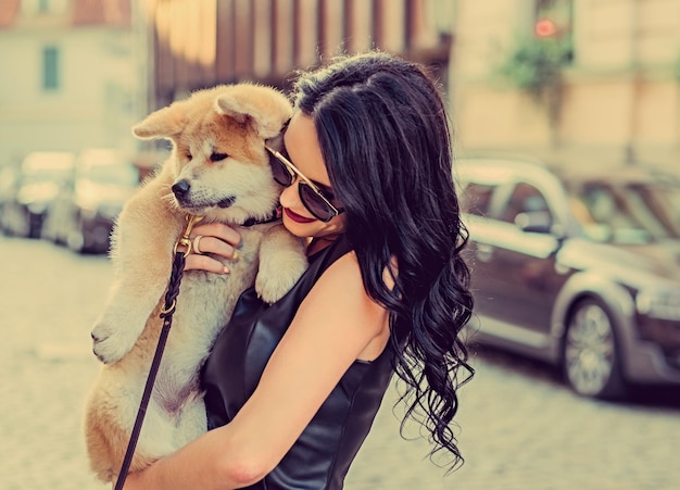 Beautiful woman with her cute dog outdoors