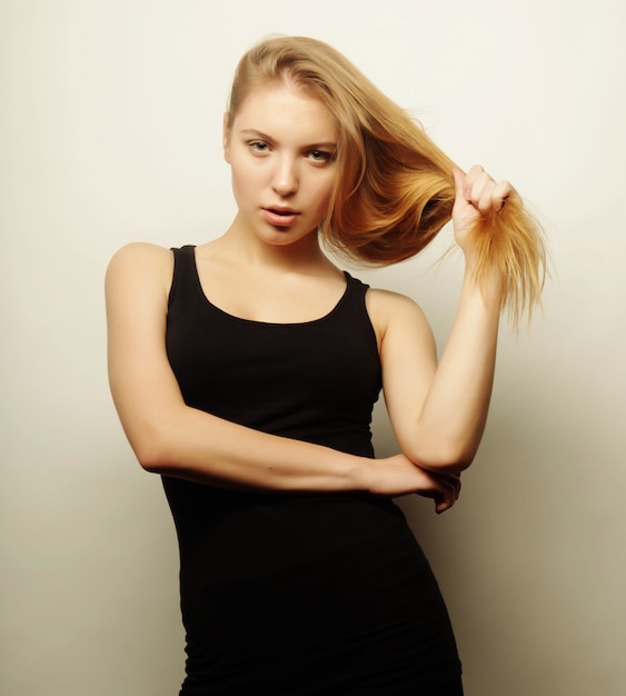 Beautiful woman with long blond hair. Fashion model posing at studio.