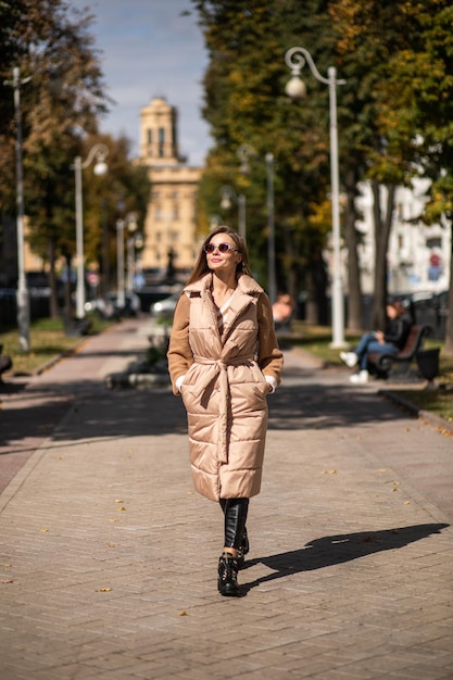 Beautiful woman with long hair advertising winter coat outdoor