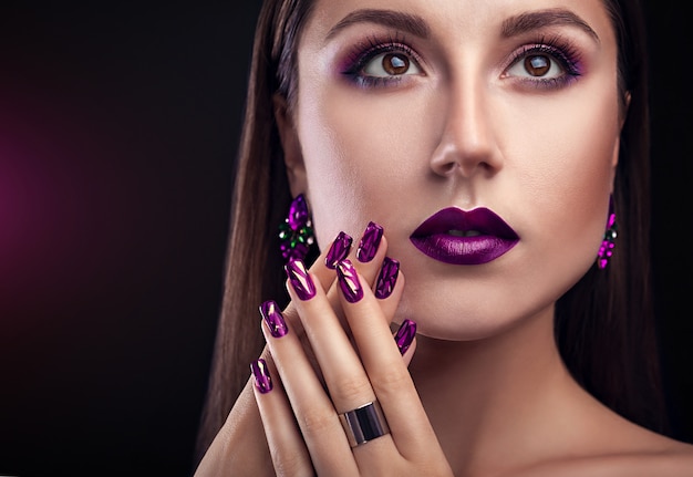 Beautiful woman with perfect make-up and manicure wearing jewellery