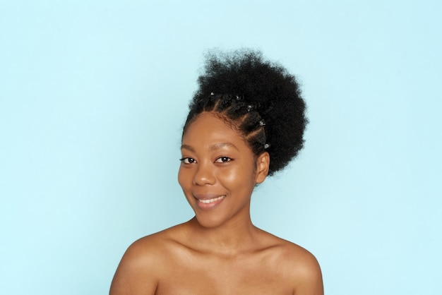 Beautiful woman with perfect skin looks at the camera Portrait of a beautiful African American woman with fresh skin Skin care moisturizing