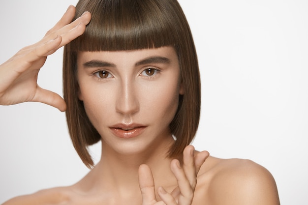 Beautiful woman with perfect straight bangs, gorgeous model with short hair glossy lips and natural daily make-up