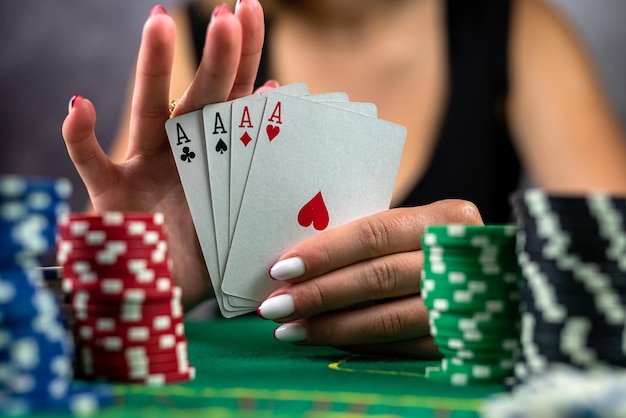 Beautiful woman with poker cards is playing low in poker