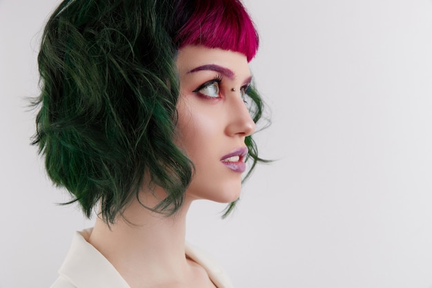 Beautiful woman with purple green professional colored hair bright eyes and lips makeup