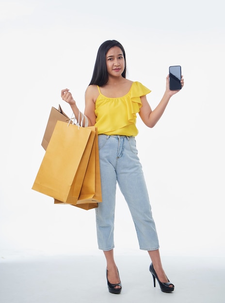 Beautiful woman with shopping bags and smartphone