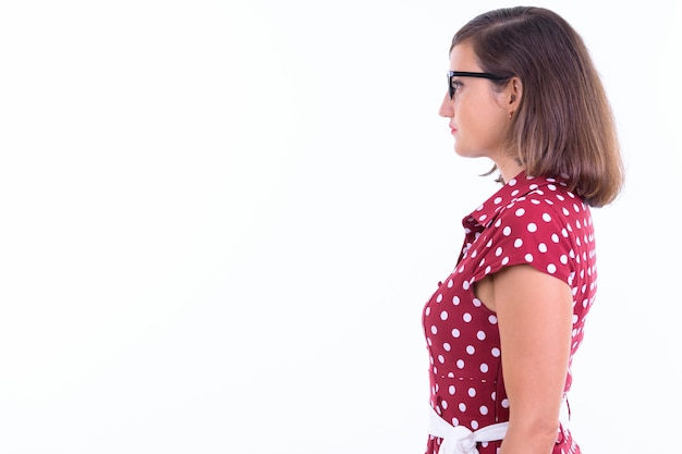 beautiful woman with short hair wearing eyeglasses isolated against white wall