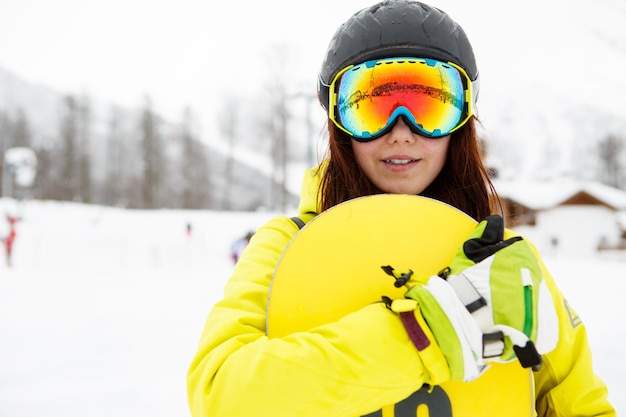 Beautiful woman with a snowboard