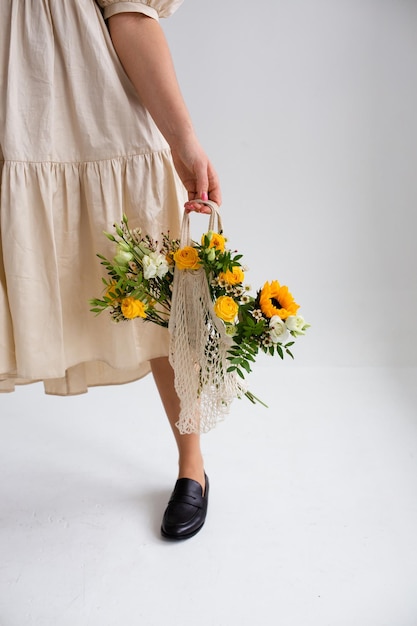 beautiful woman with spring yellow bouquet of flowers spring and beauty concept