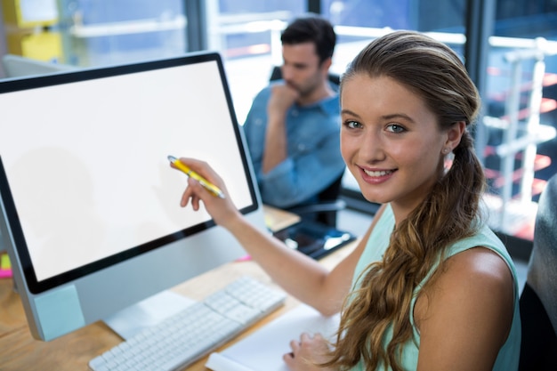 Beautiful woman working on desktop pc in office