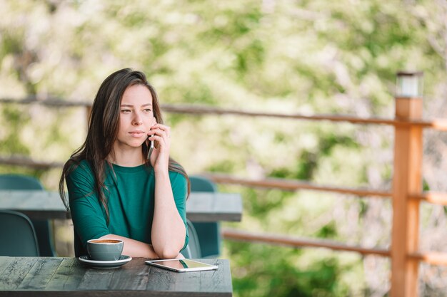 Beautiful woman works from home on terrace