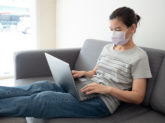 Beautiful woman works at home on her laptop