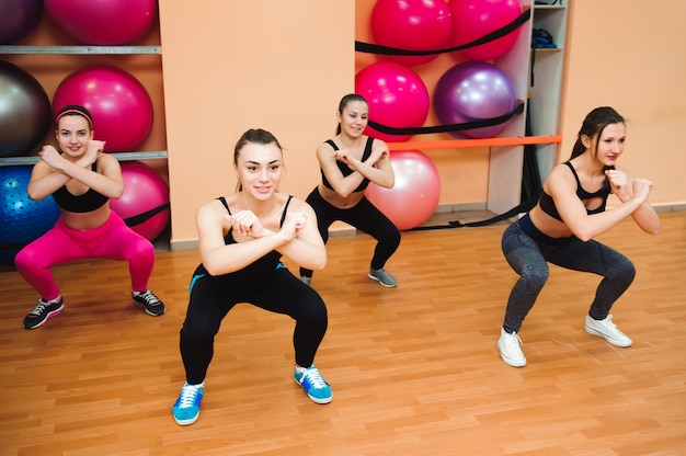 Beautiful women exercising aerobics in fitness club.