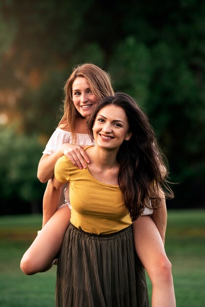 Beautiful women having fun in the park. Friends and summer concept.