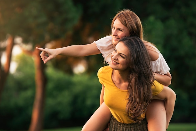 Beautiful women having fun in the park. Friends and summer concept.