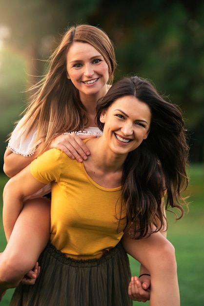 Beautiful women having fun in the park. Friends and summer concept.