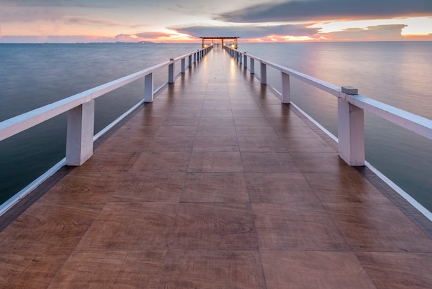 beautiful wooded bridge in the port at sunset