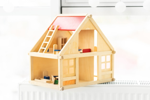 Photo beautiful wooden dollhouse on light room background