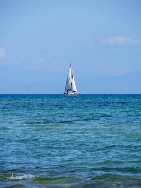 Beautiful yacht on a cloudy day on calm Aegean Sea on island of Evia, Greece