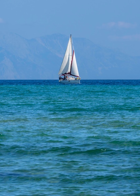 Beautiful yacht on a cloudy day on calm Aegean Sea on island of Evia, Greece