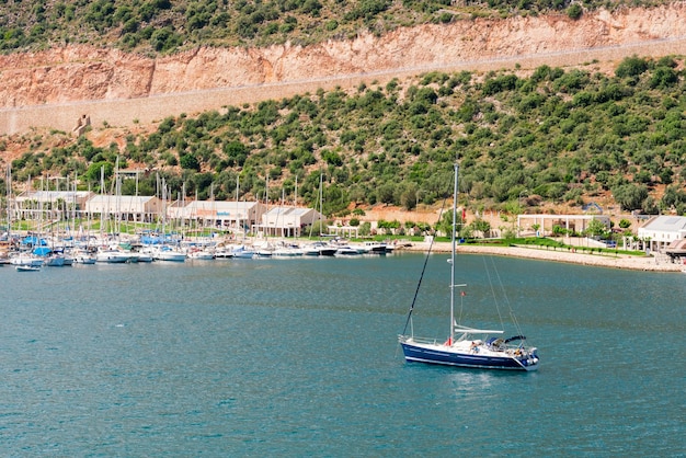 Beautiful yacht in sea with on background of the pier Peaceful atmosphere