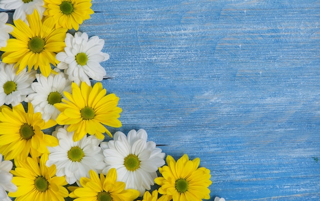 Beautiful yellow and white flowers on a wooden table