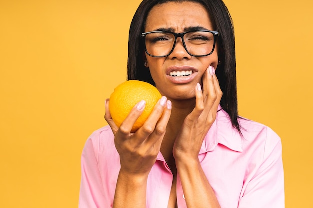 Beautiful young african american woman over isolated background touching mouth with hand with painful expression because of toothache or dental illness on teeth Dentist concept