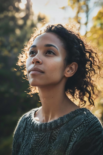 Beautiful young african american woman with curly hair in autumn park