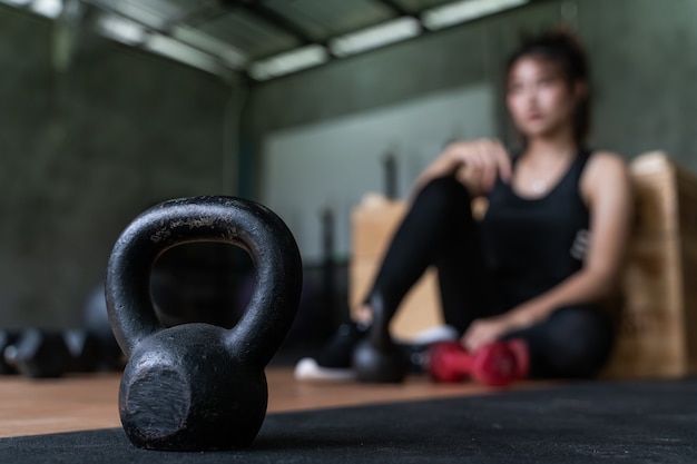 Beautiful young asian gorlw working out at the gym for health and fitness