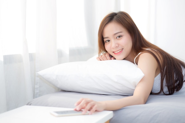 Beautiful young asian woman hand of turn off alarm on call mobile phone