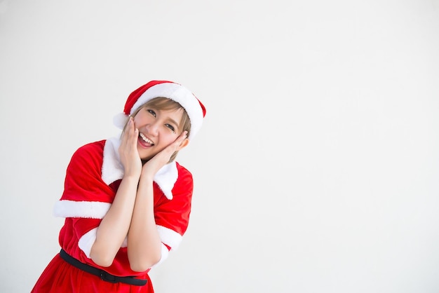 Photo beautiful young asian woman in santa claus clothes on white backgroundthailand peoplesent happiness for childrenmerry christmaswelcome to winterhappy woman concept