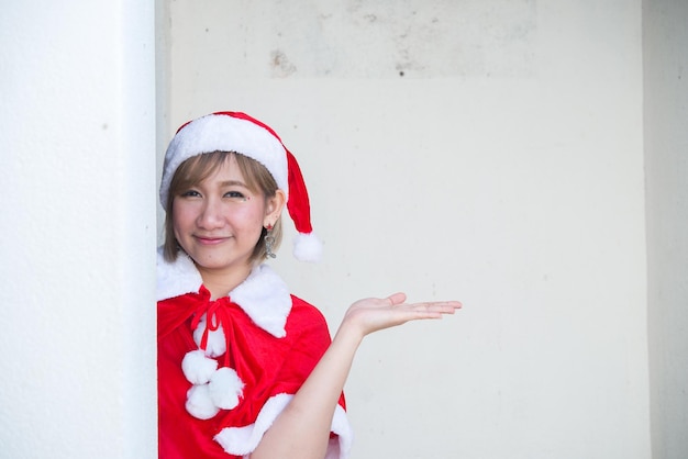 Beautiful young asian woman in Santa Claus clothes on white backgroundThailand peopleSent happiness for childrenMerry christmasWelcome to winterHappy woman concept