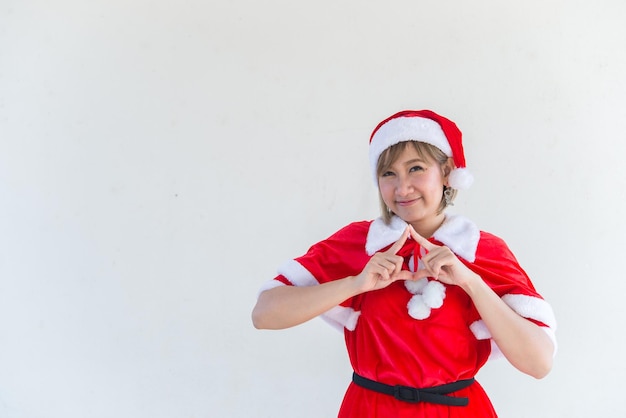 Beautiful young asian woman in Santa Claus clothes on white backgroundThailand peopleSent happiness for childrenMerry christmasWelcome to winterHappy woman concept