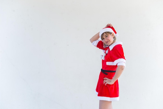 Beautiful young asian woman in Santa Claus clothes on white backgroundThailand peopleSent happiness for childrenMerry christmasWelcome to winterHappy woman concept