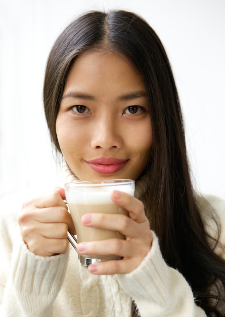 Beautiful young asian woman smiling with cup of coffee