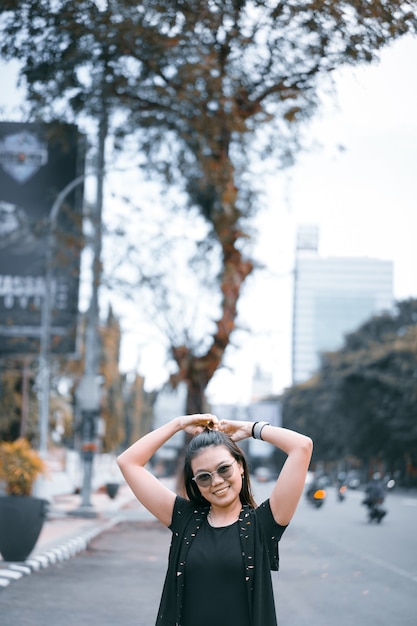 Beautiful Young Asian woman wearing authentic dress posing on the city street