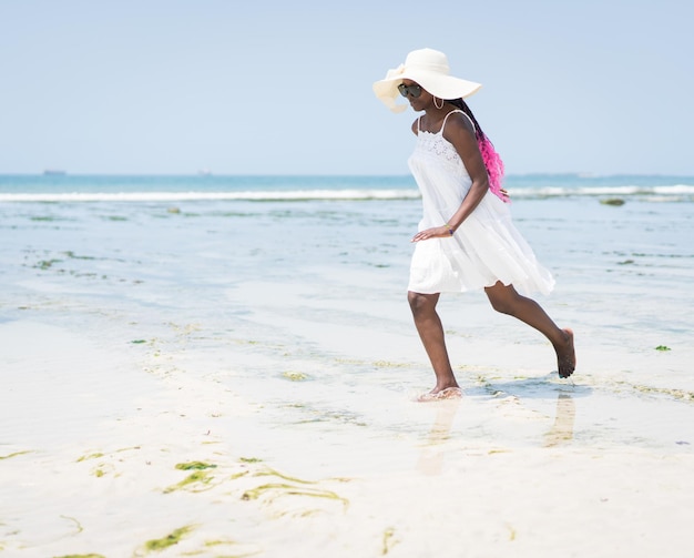 Beautiful young black African American woman on the tropical beach