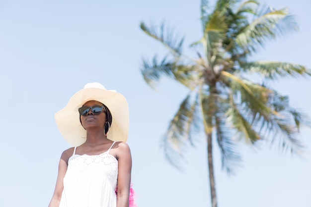 Beautiful young black African American woman on the tropical beach