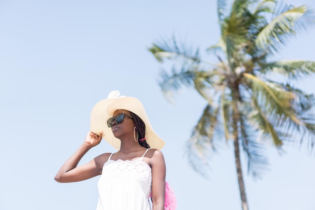 Beautiful young black African American woman on the tropical beach