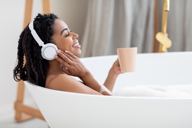 Beautiful Young Black Lady Taking Bath Listening Music And Drinking Coffee