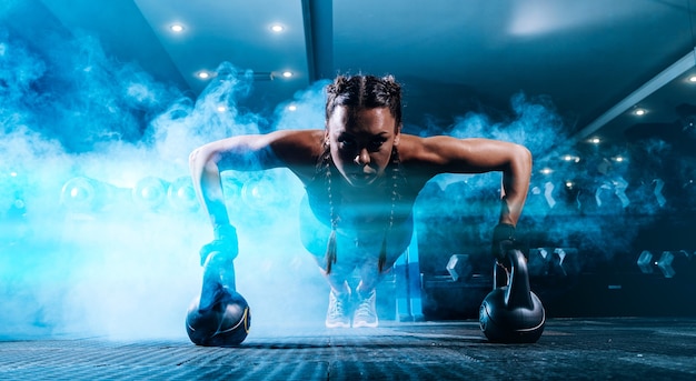 Beautiful young black sportswoman in the gym