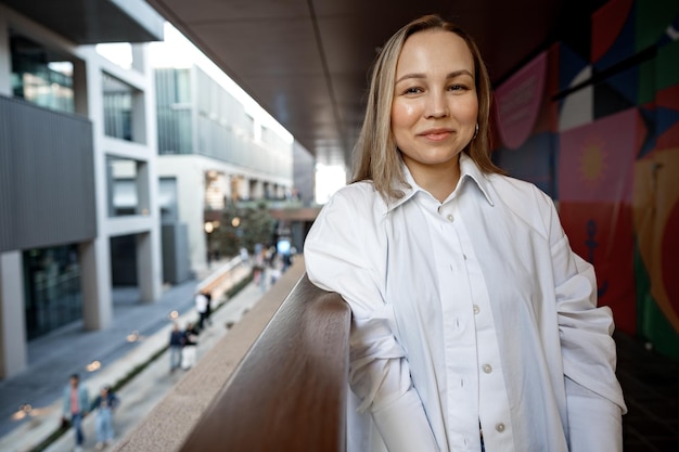 Beautiful young blonde businesswoman in urban background