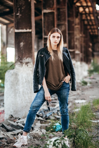 Beautiful young blonde girl  in a blank green military T-shirt and Leather Jacket