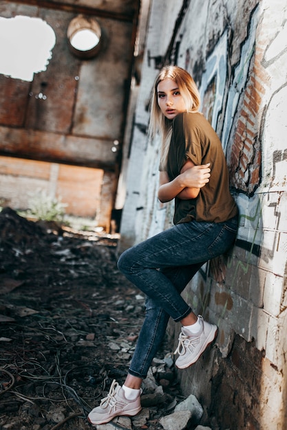 Beautiful young blonde girl  in a blank green military T-shirt