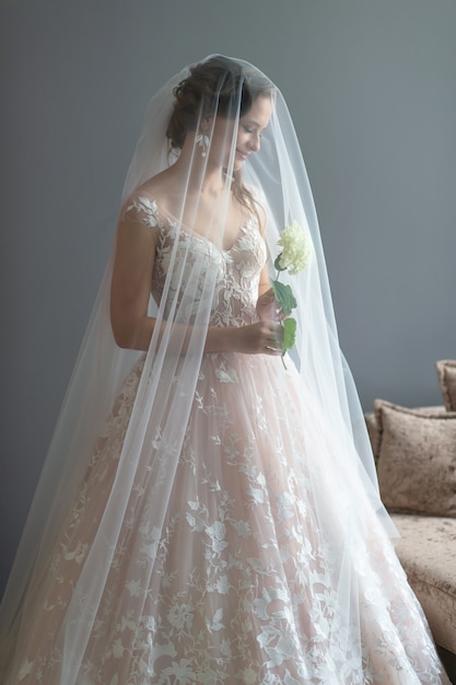 Beautiful young bride posing in wedding dress