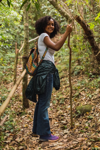 Beautiful young brunette hiking in the jungle